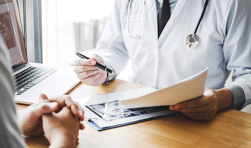 A doctor assessing a patient for bariatric surgery suitability.