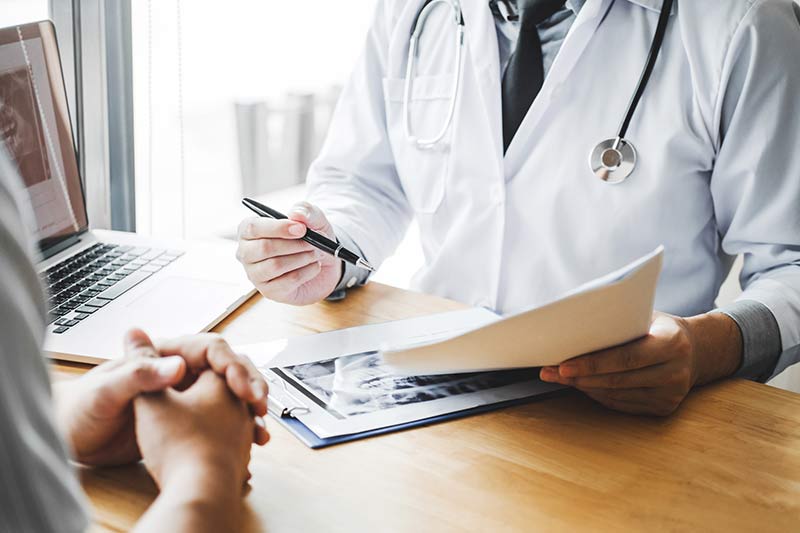 A doctor assessing a patient for bariatric surgery suitability.